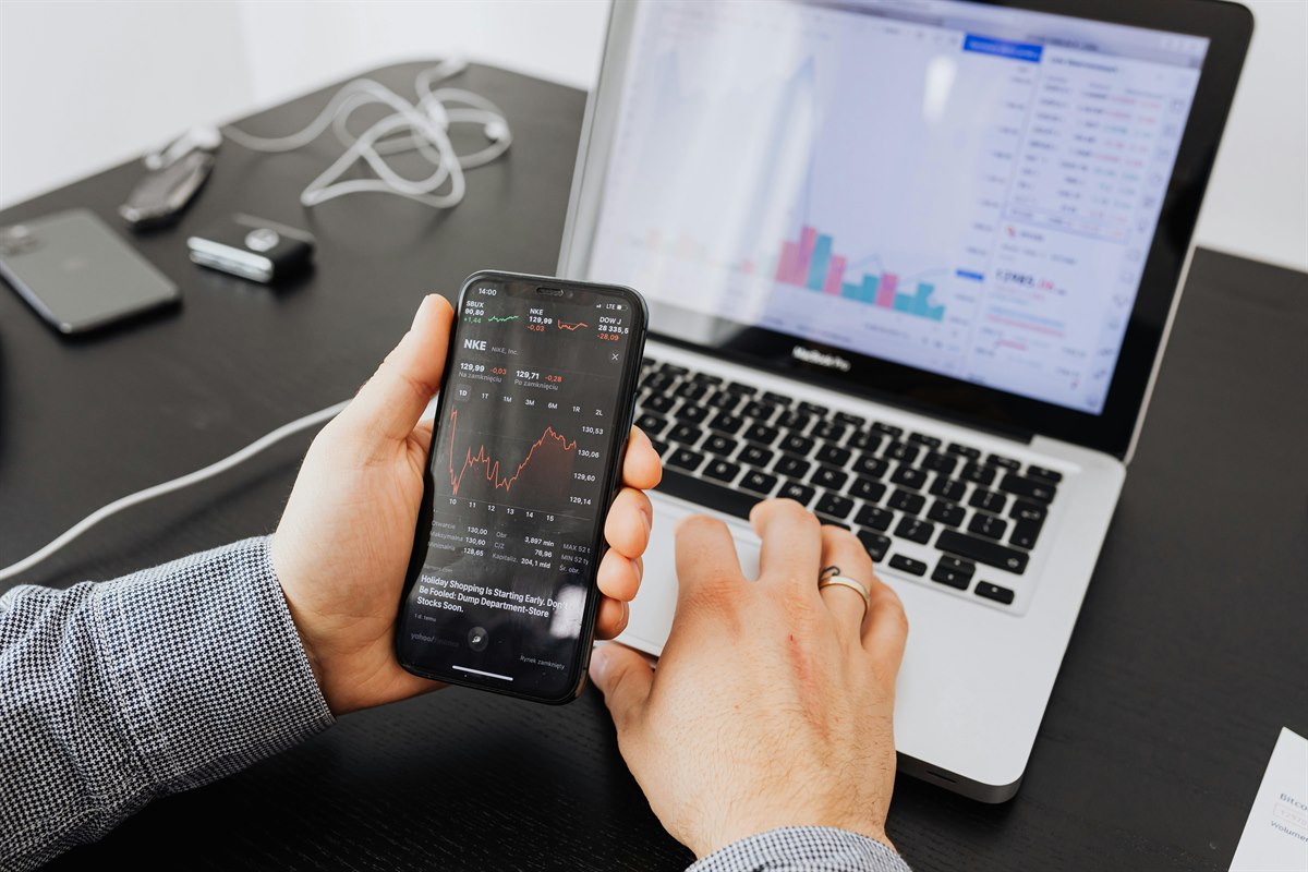 Digital financial chart analysis on mobile and laptop